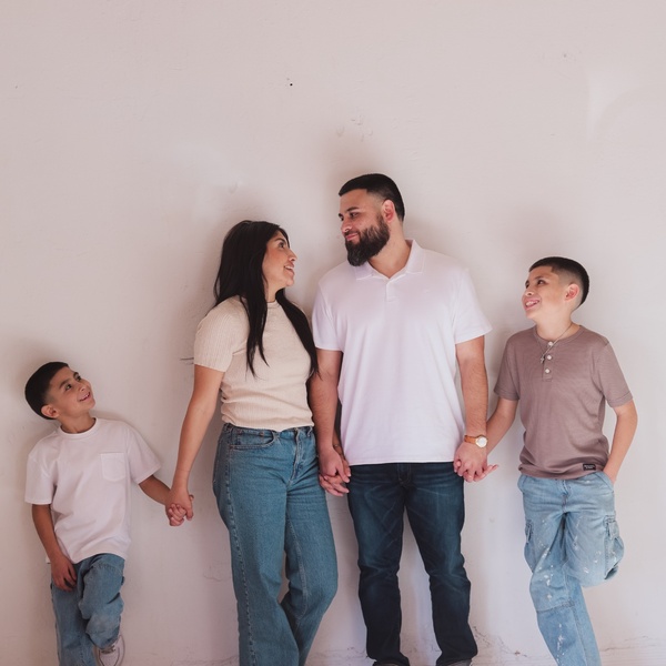 The Hipolito family supporting strong schools and community values Mariah Hipolito standing with her husband and two sons, holding hands and smiling